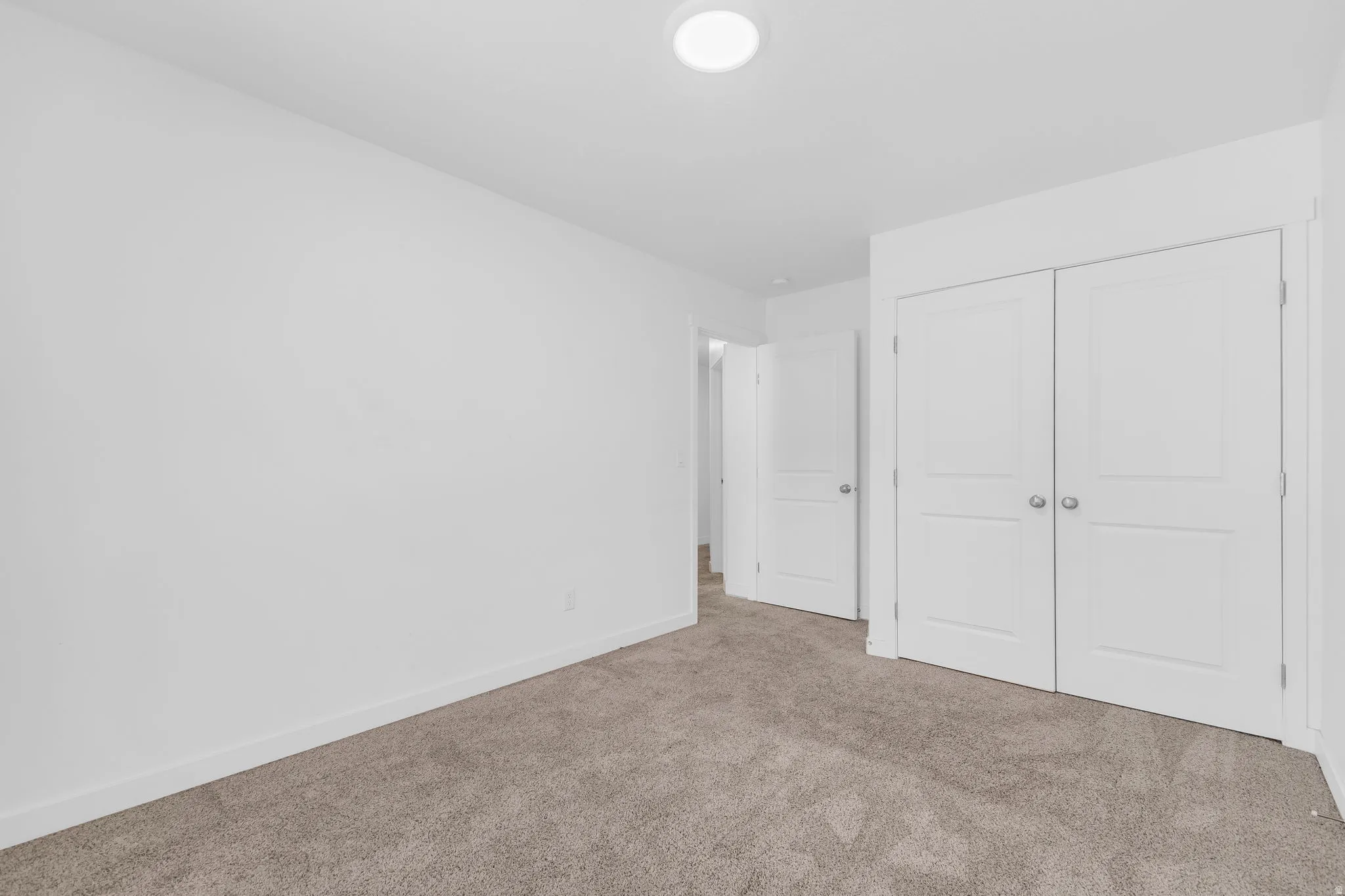 Unfurnished bedroom with carpet floors and a closet