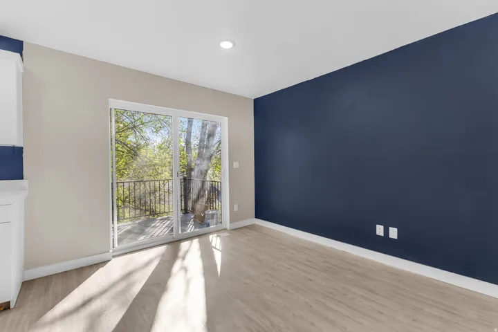 Empty room featuring light wood finished floors and recessed lighting