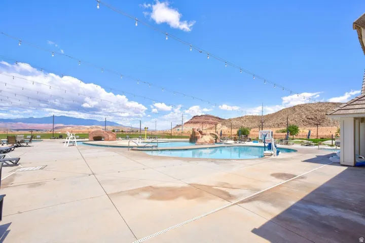 Community pool featuring a mountain view and a patio