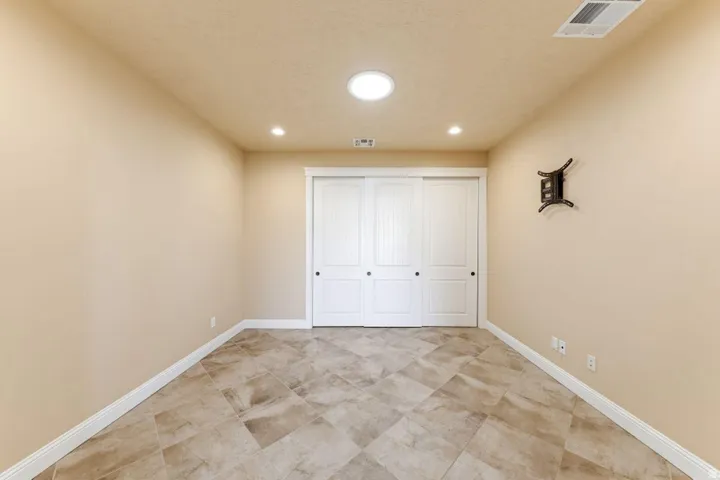 Unfurnished bedroom featuring a closet and recessed lighting