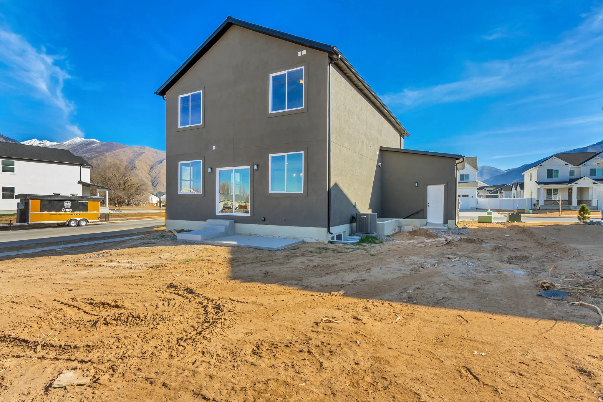 Rear view of property featuring a mountain view and stucco siding