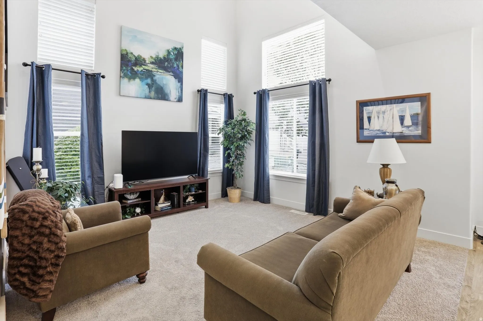 Living room with light carpet and a high ceiling