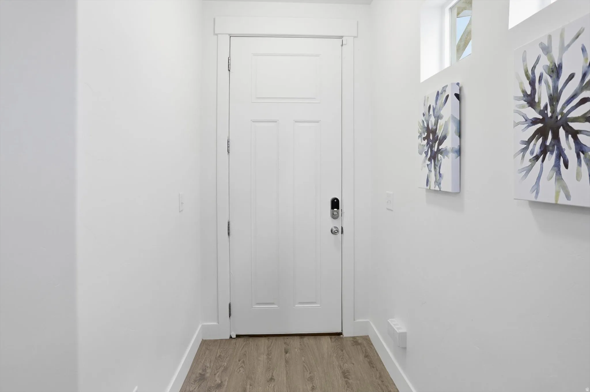 Entryway featuring wood finished floors and baseboards