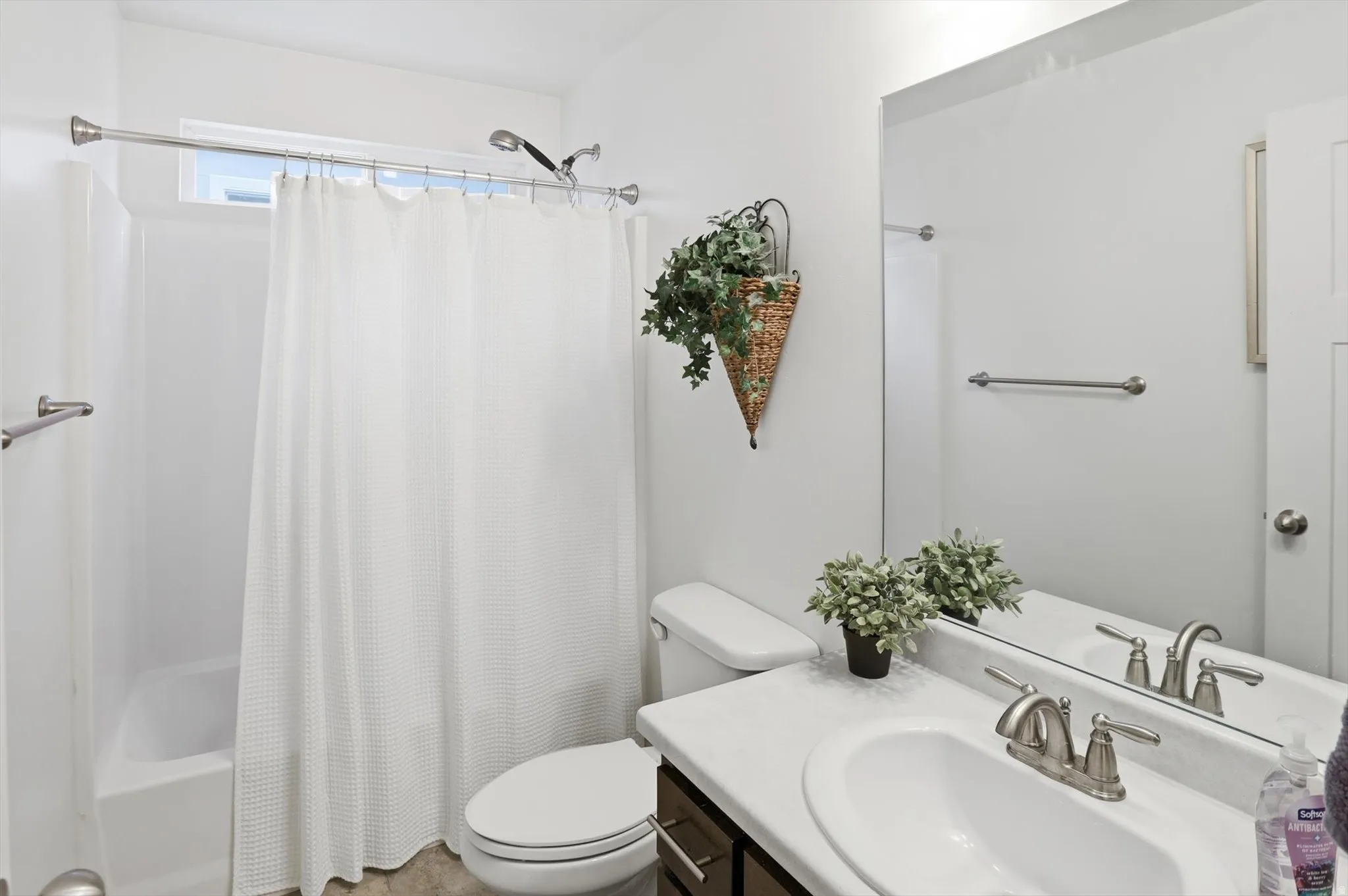 Bathroom featuring vanity and shower / tub combo