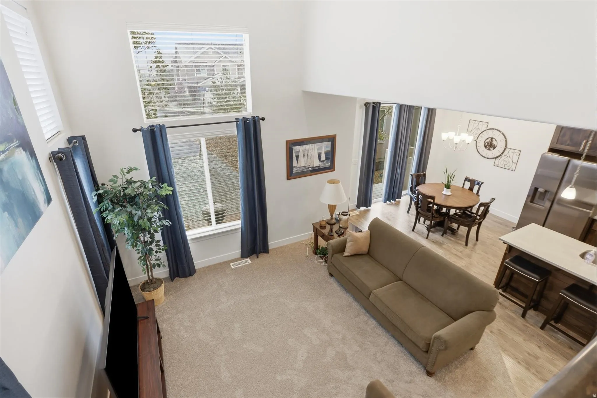 Living room featuring suspended lighting and plenty of natural light