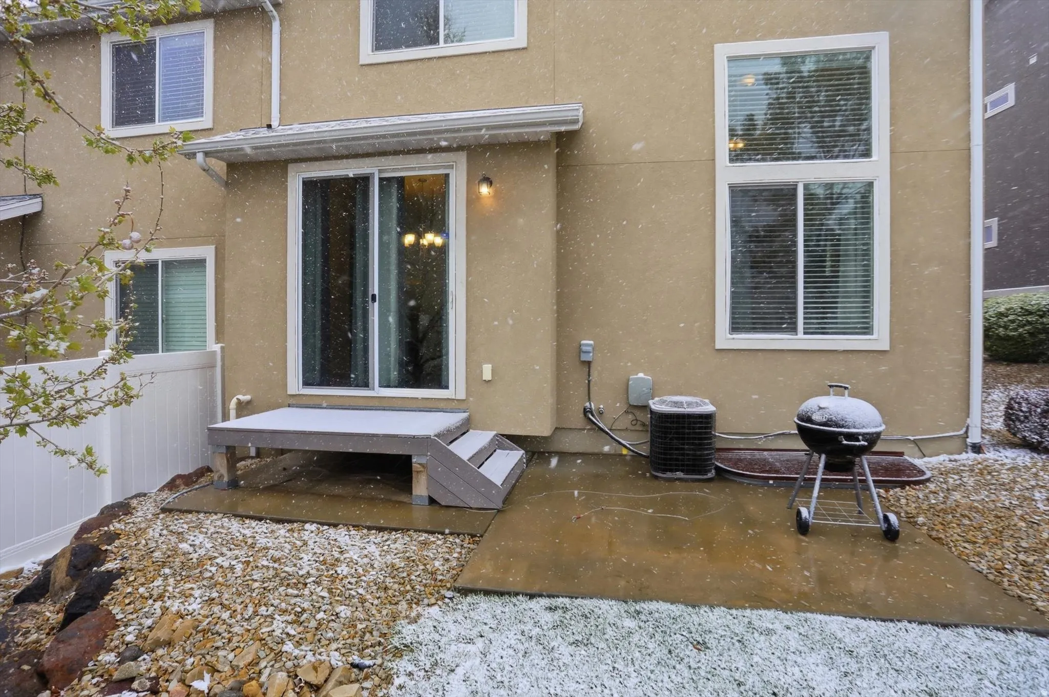 Back of house with stucco siding and a patio area