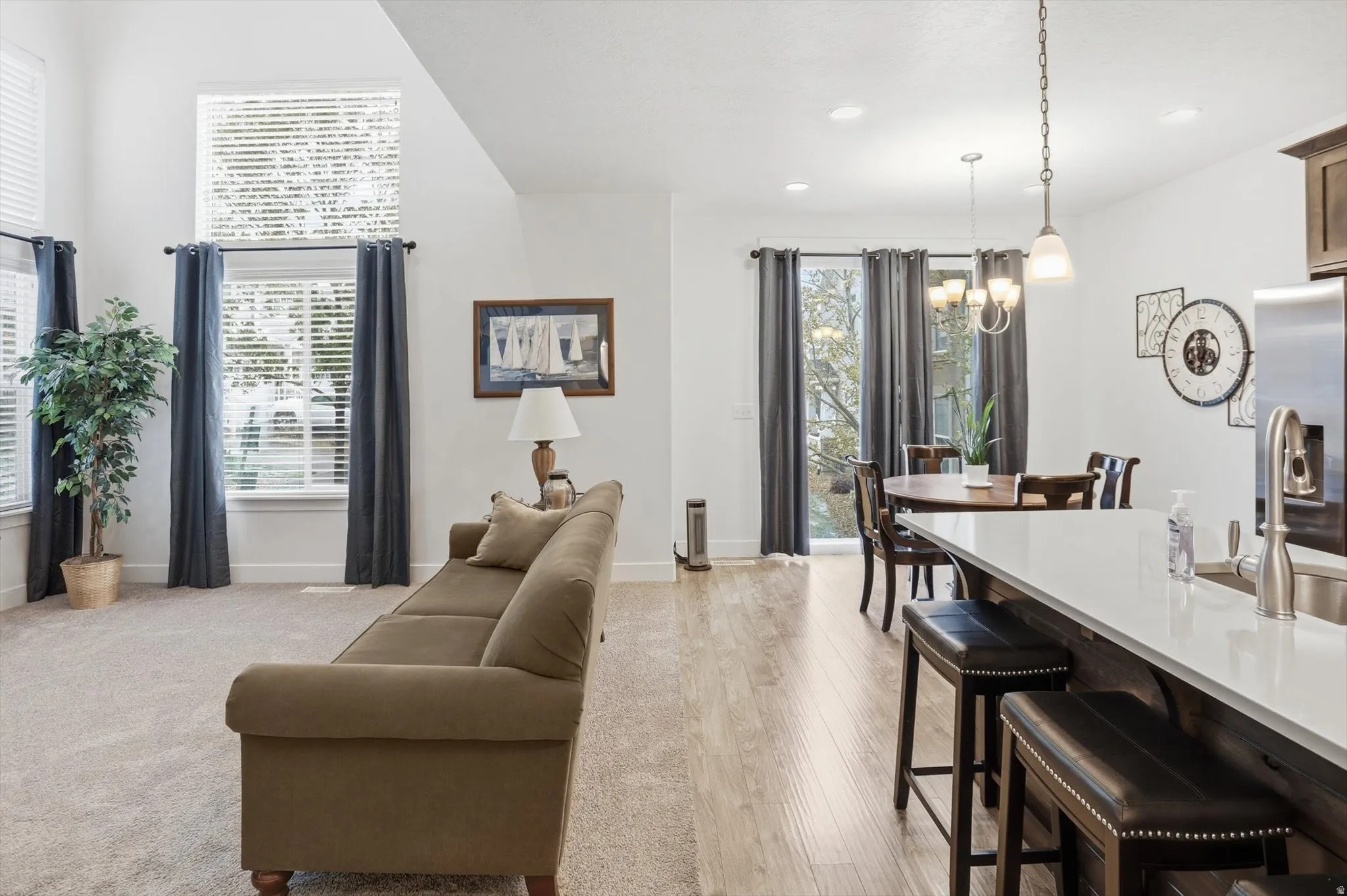 Living room with light wood-style floors and a chandelier