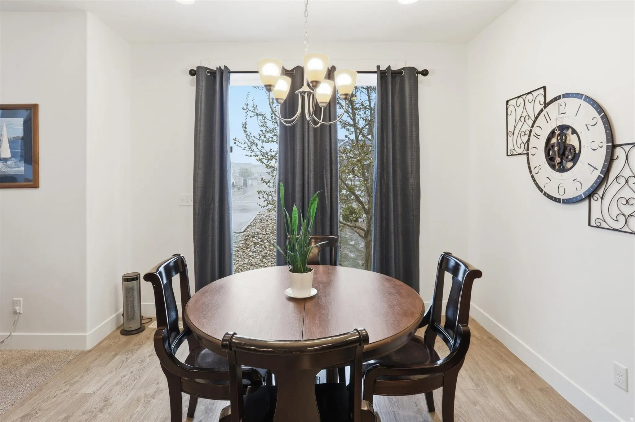 Dining room with light wood-style flooring and hanging lights