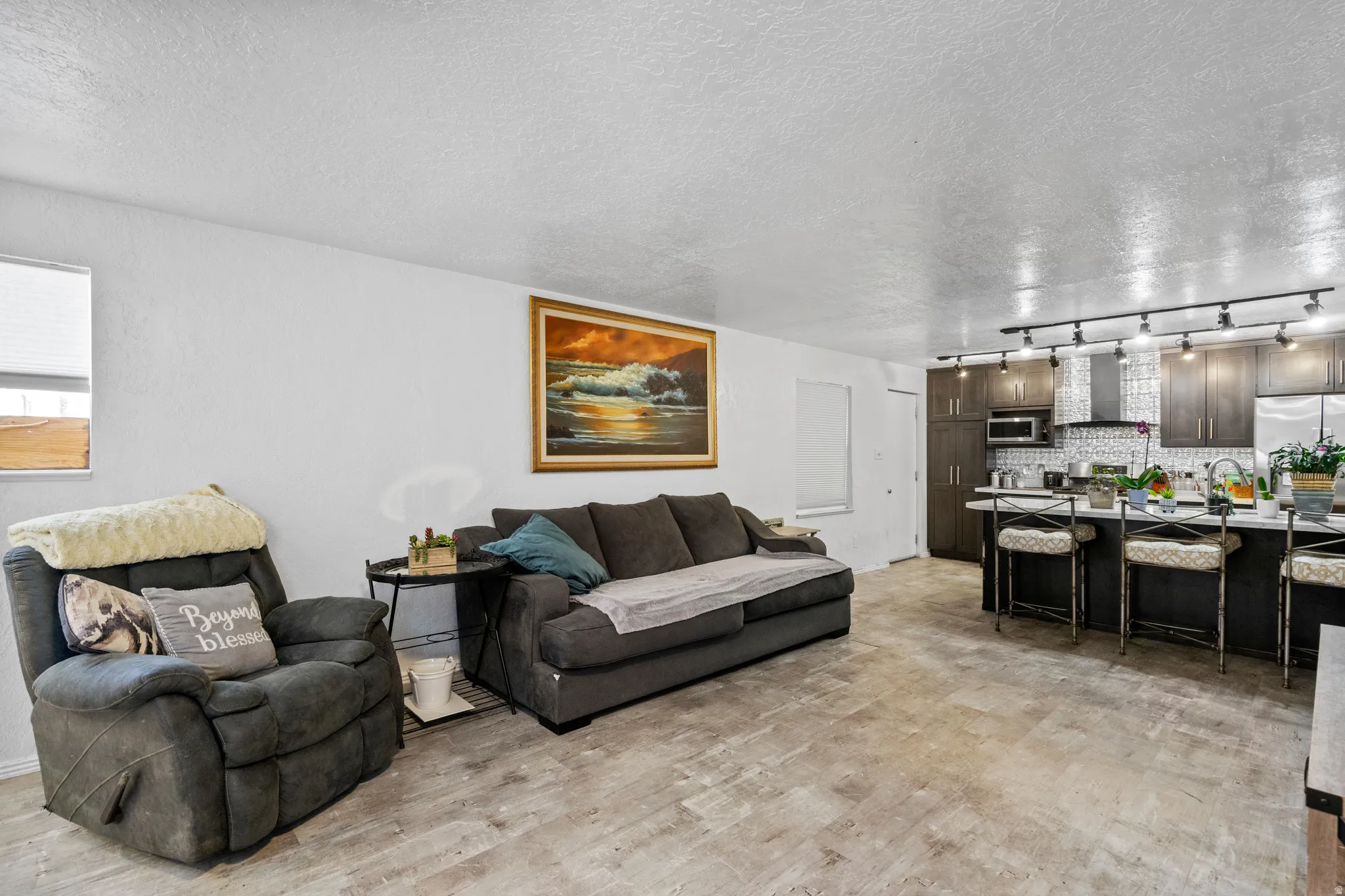 Living room featuring a textured ceiling and light wood finished floors