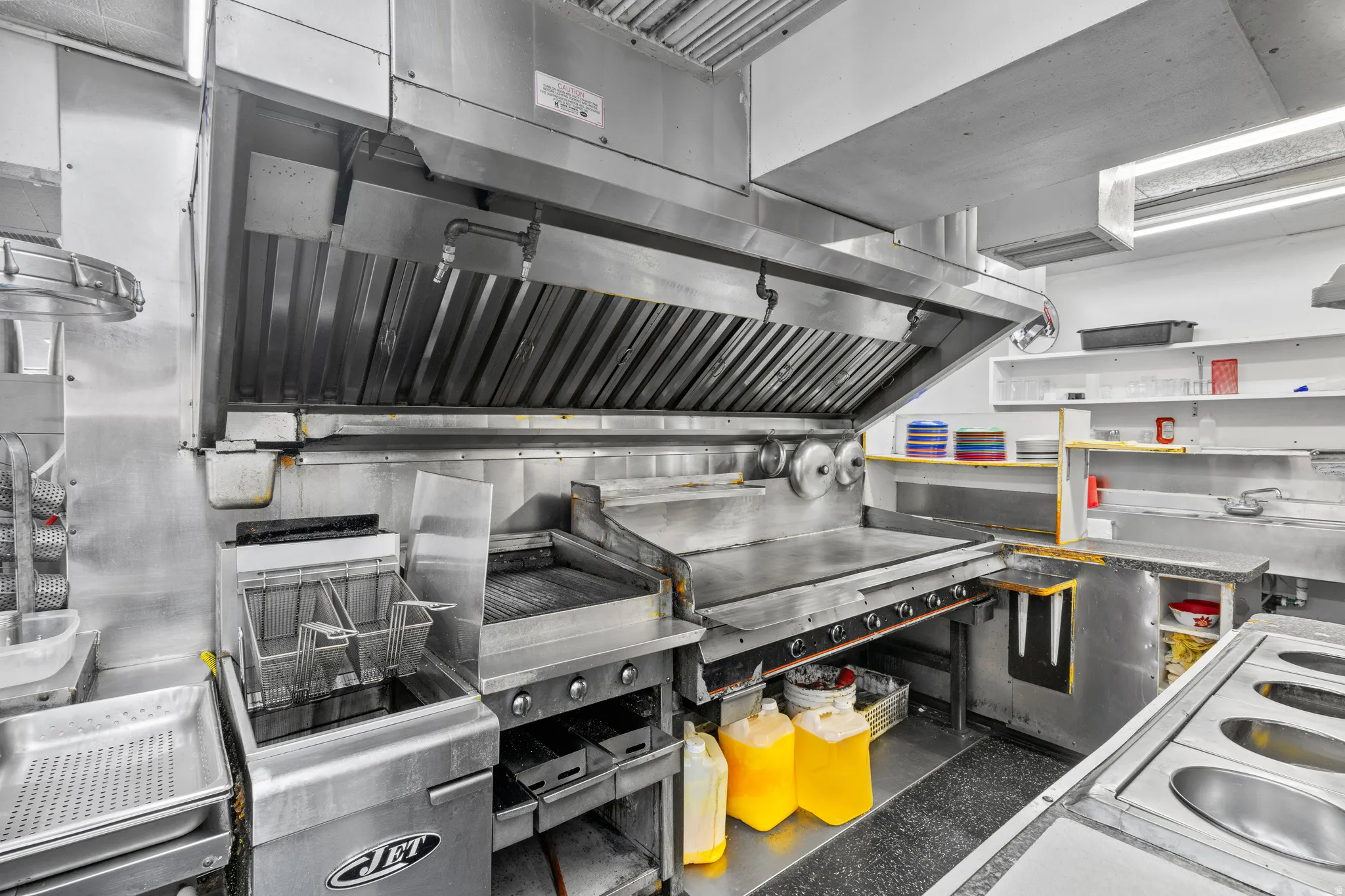 Kitchen with exhaust hood and white electric stove