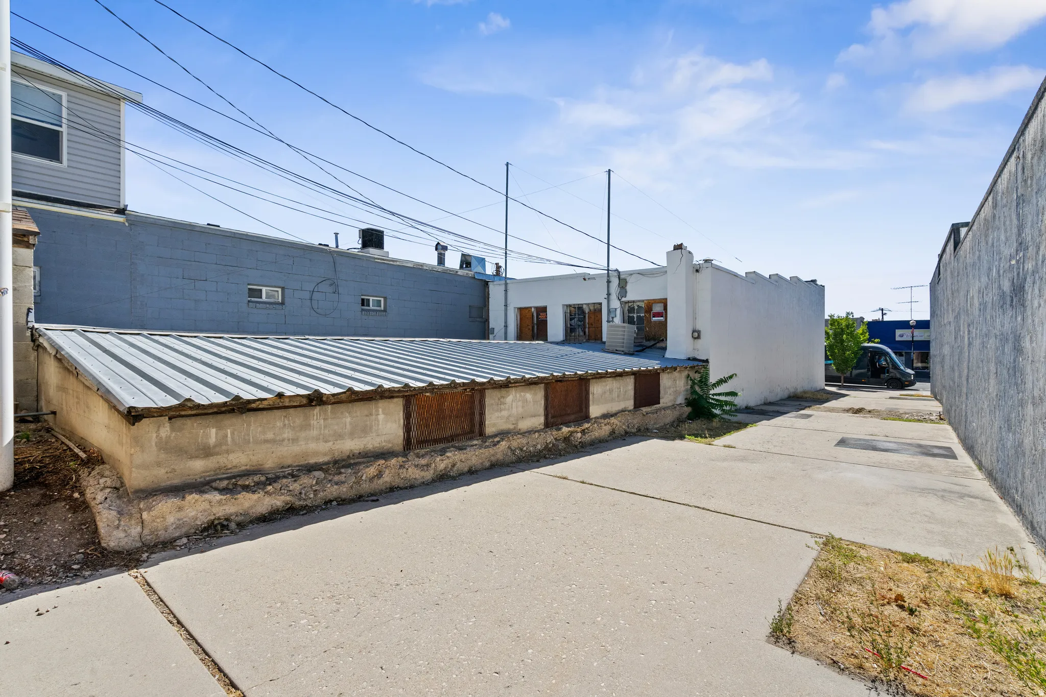 Exterior space featuring stucco siding and a metal roof