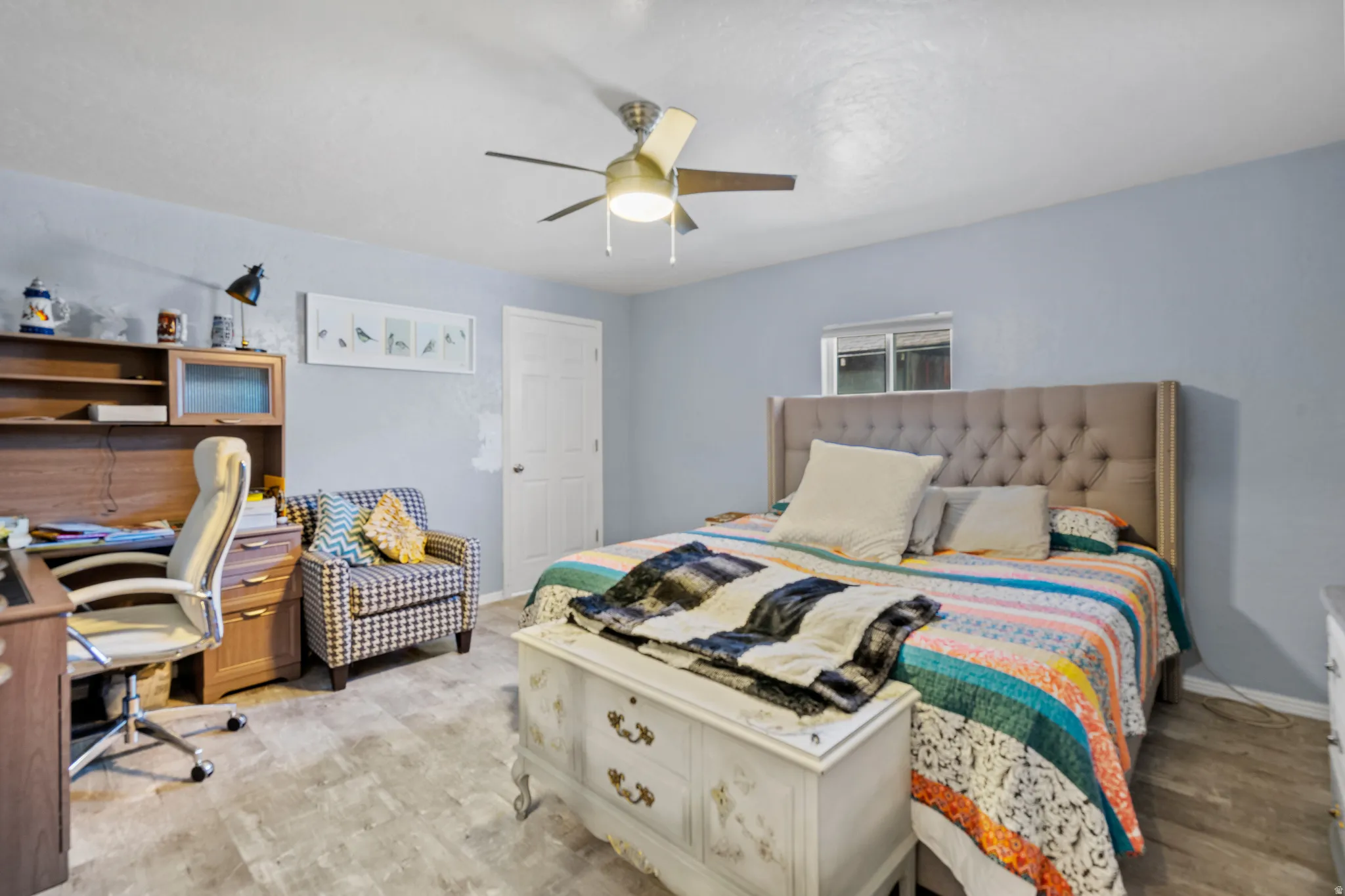 Bedroom featuring an office area, ceiling fan, and light wood finished floors