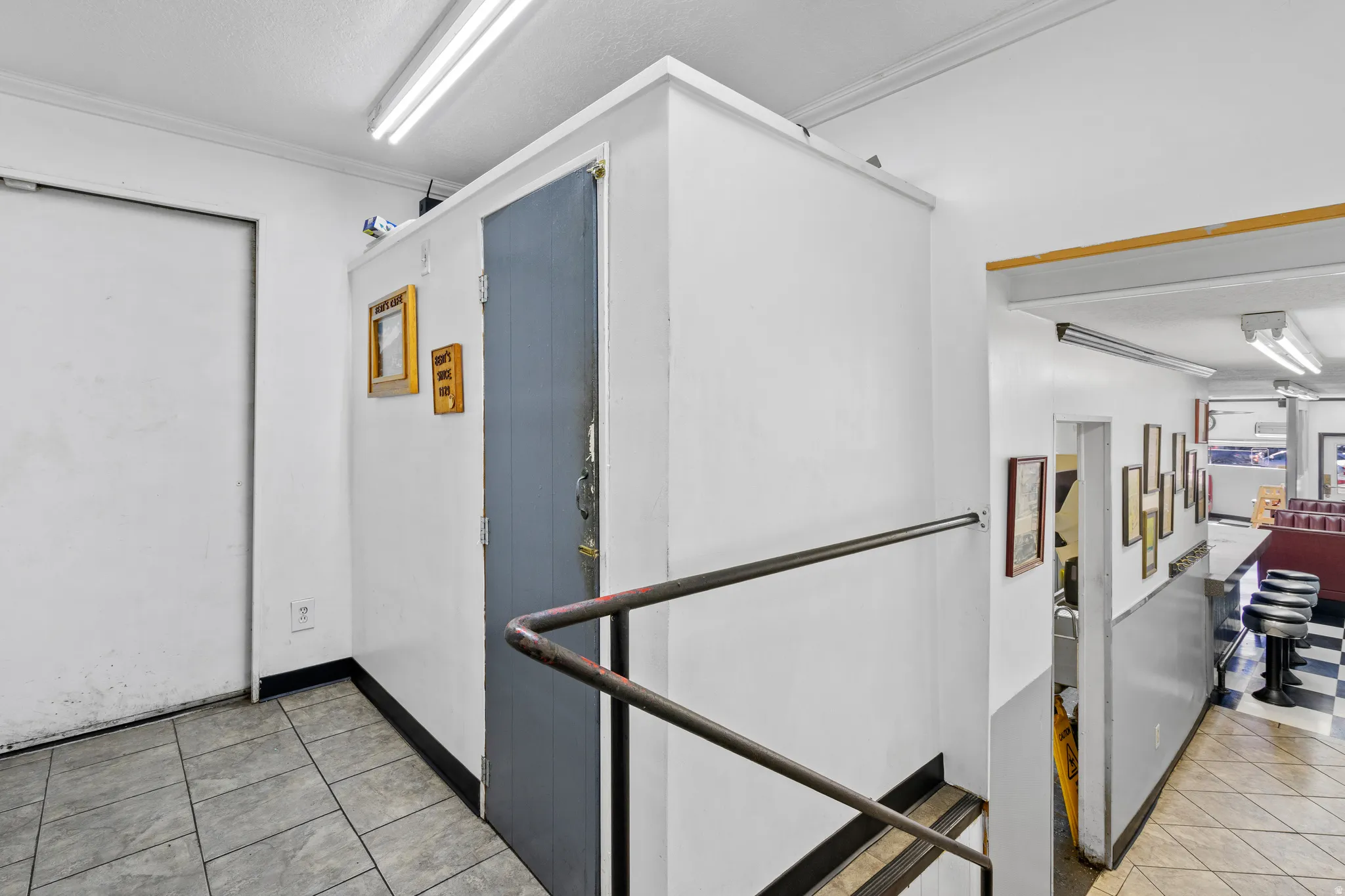 Hall featuring light tile patterned floors