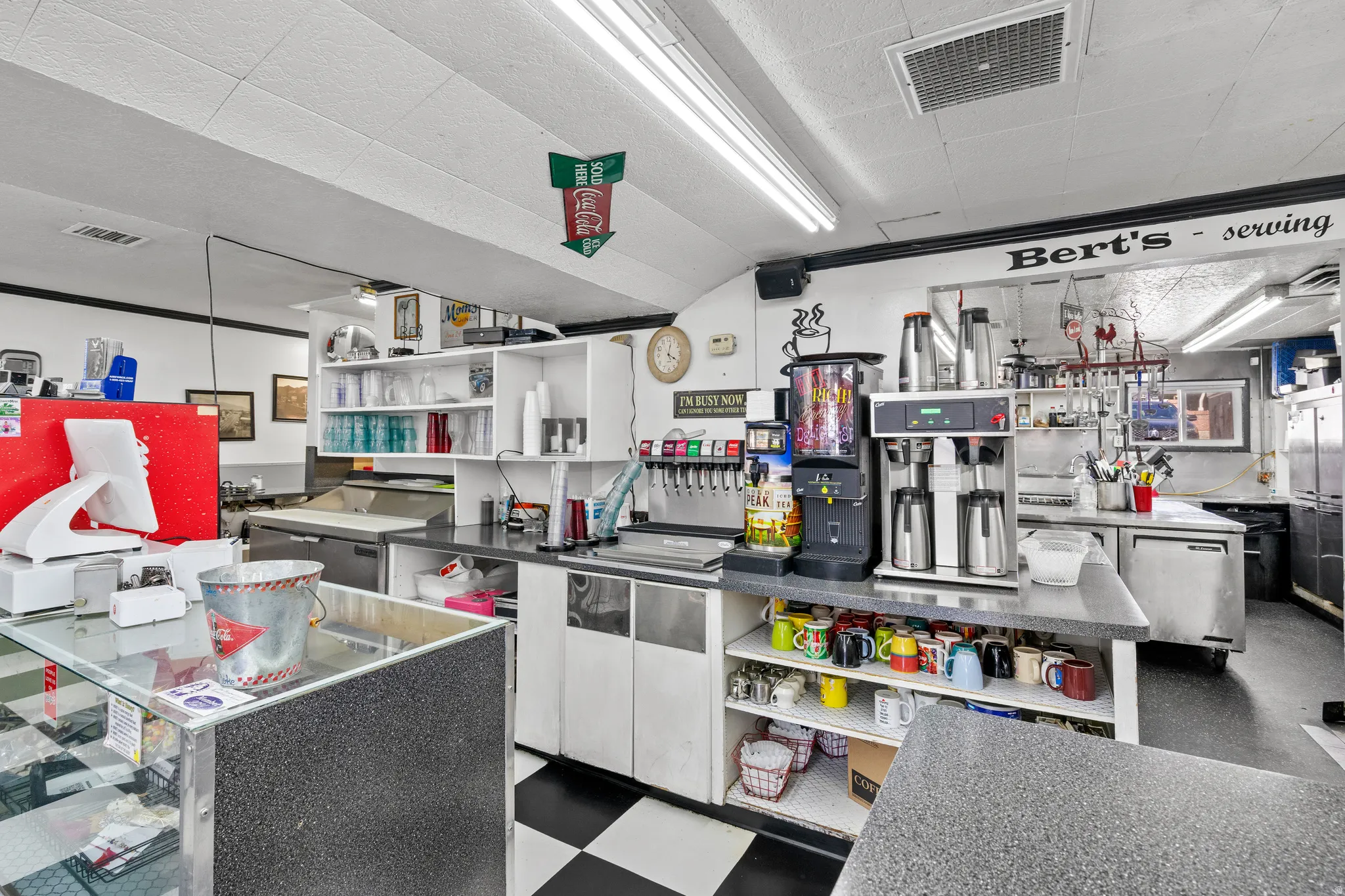 Kitchen with a center island, stainless steel fridge, and dark countertops