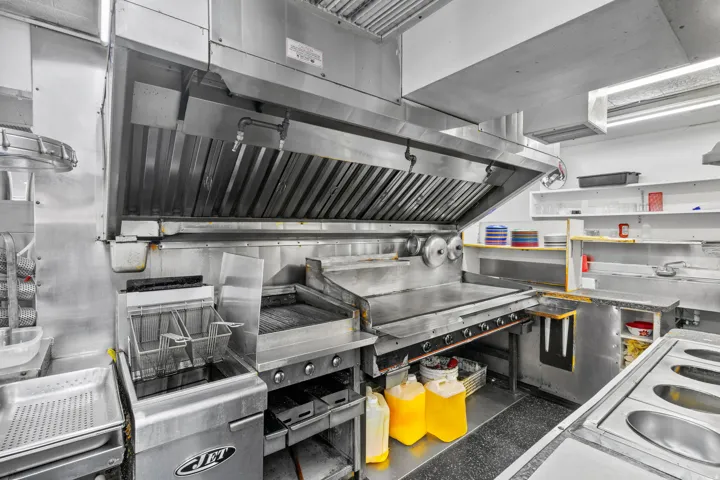 Kitchen with exhaust hood and white electric stove