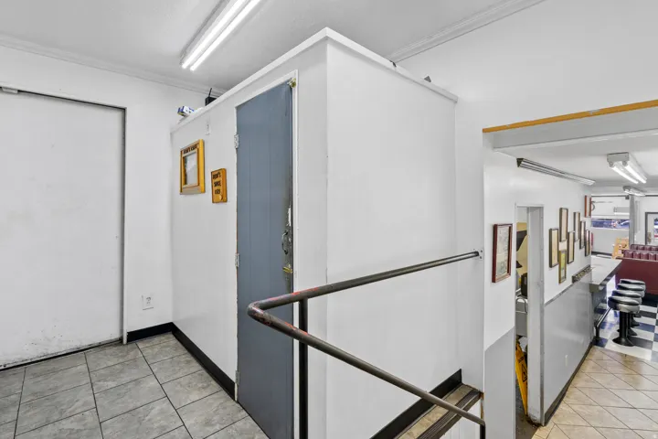 Hall featuring light tile patterned floors