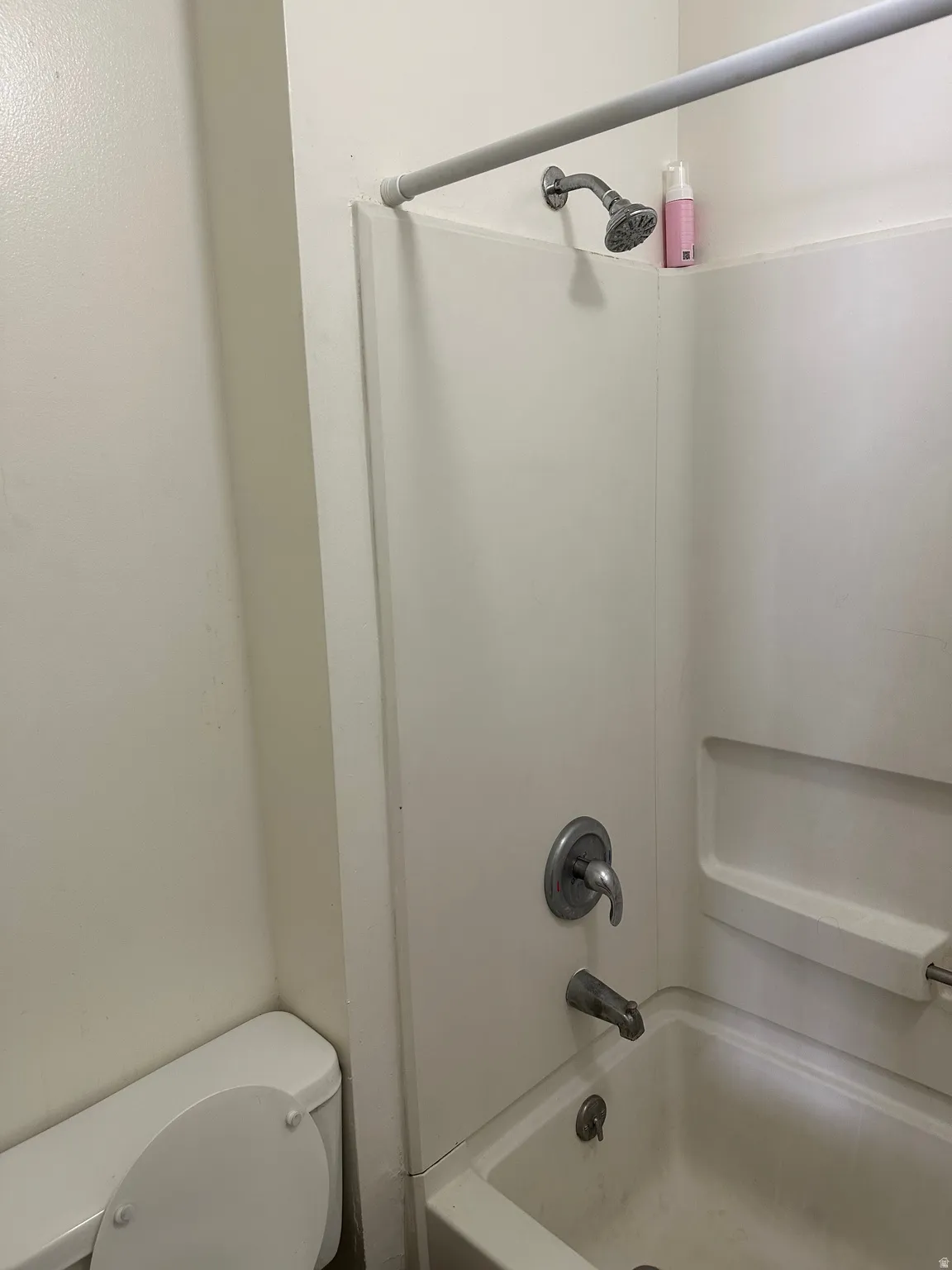 Bathroom with toilet and bathing tub / shower combination