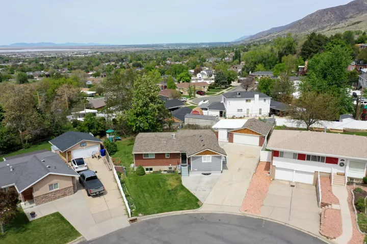 Aerial perspective of suburban area with a mountainous background