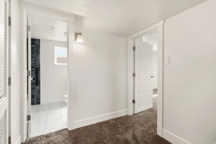 Hall with light carpet and light marble finish floors