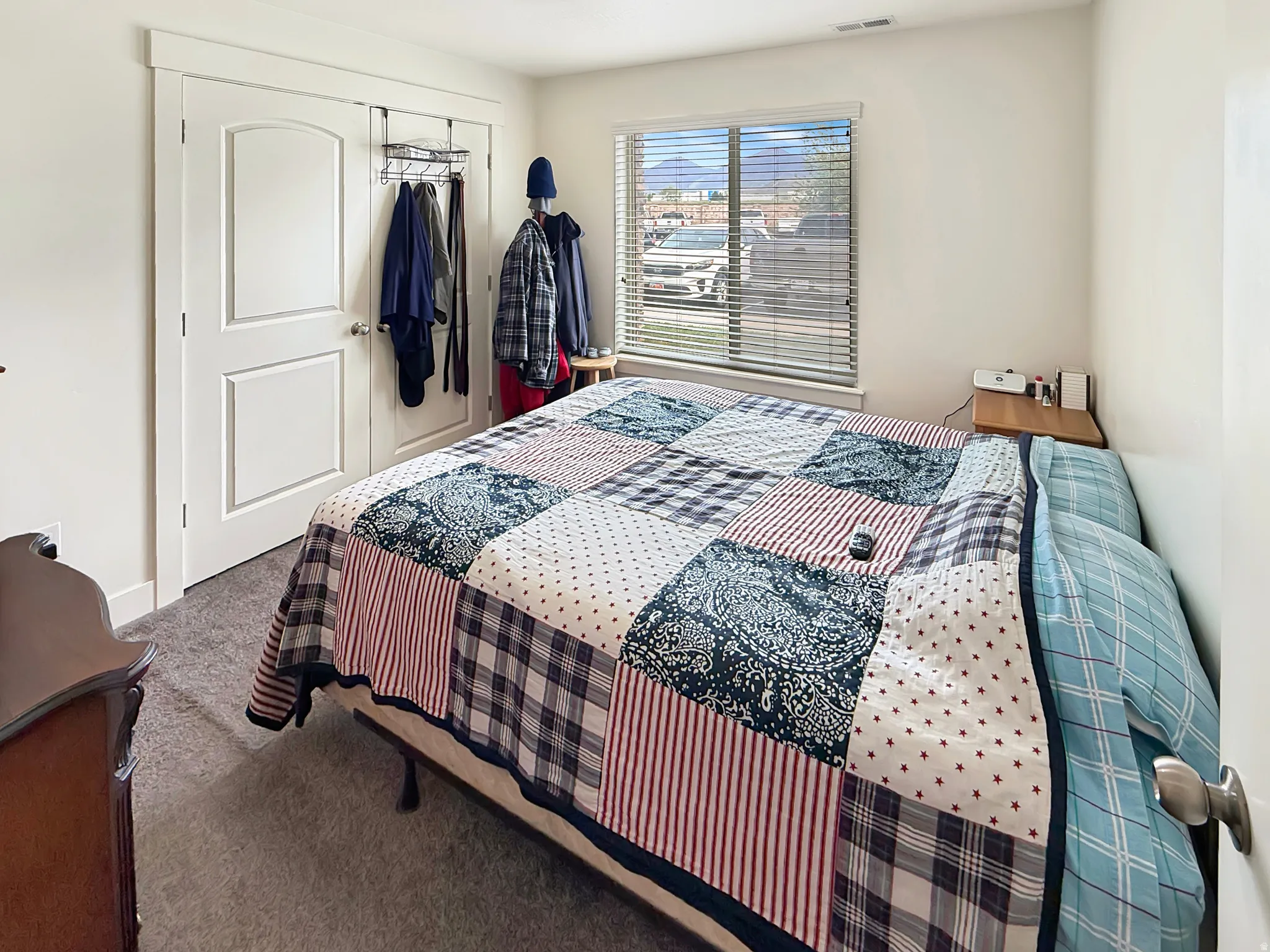 Carpeted bedroom featuring a closet and baseboards