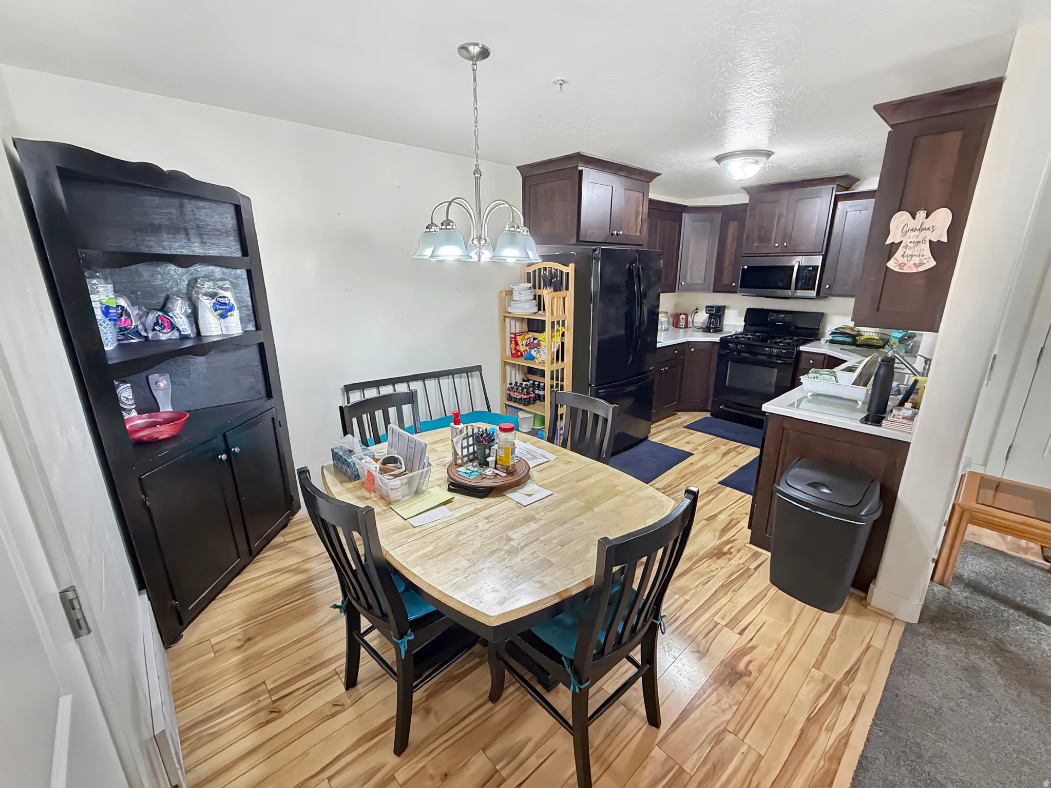 Dining space featuring light wood-type flooring and suspended lighting