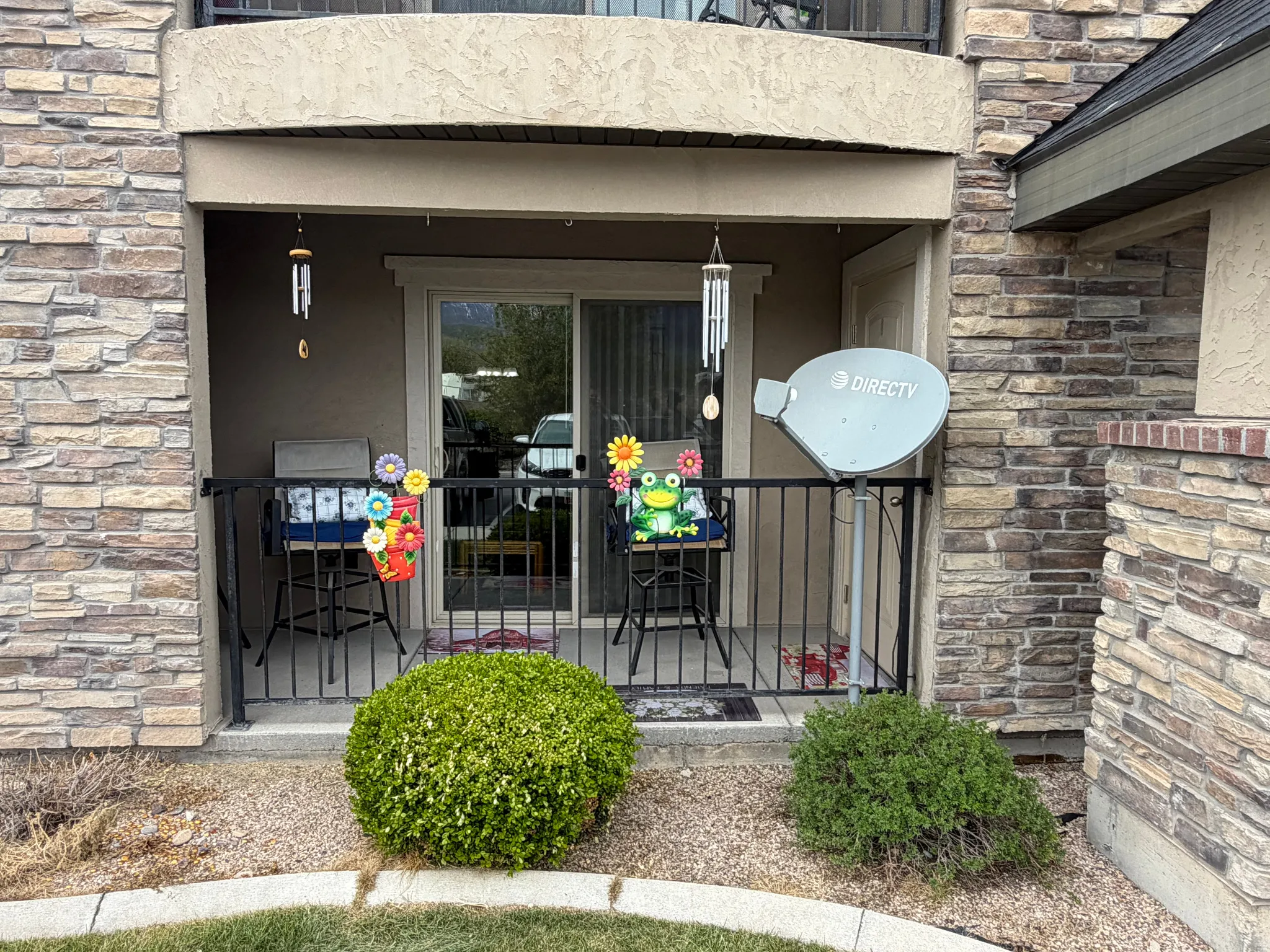 Property entrance featuring stucco siding and stone siding