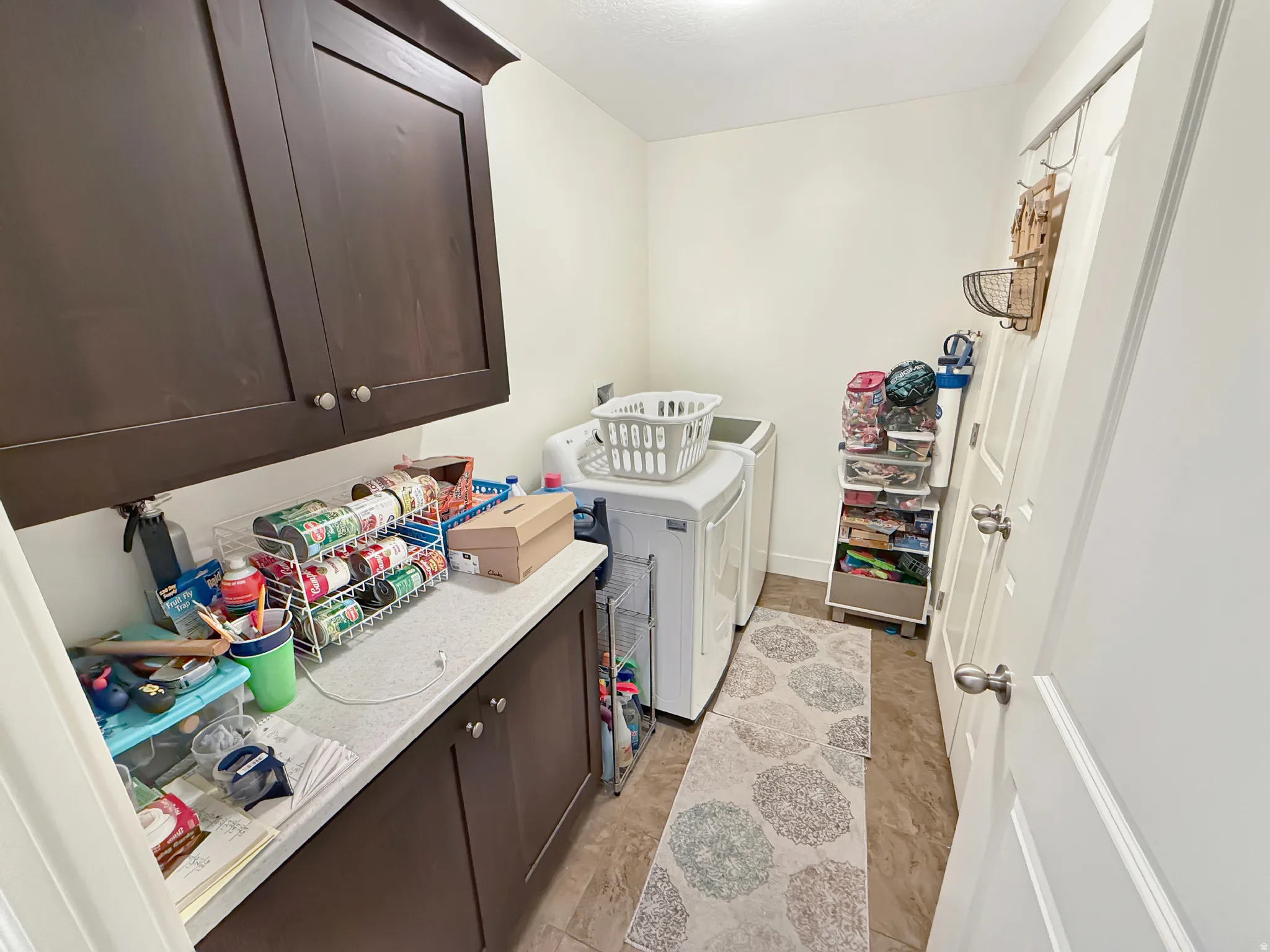 Laundry room featuring cabinet space and washer and clothes dryer