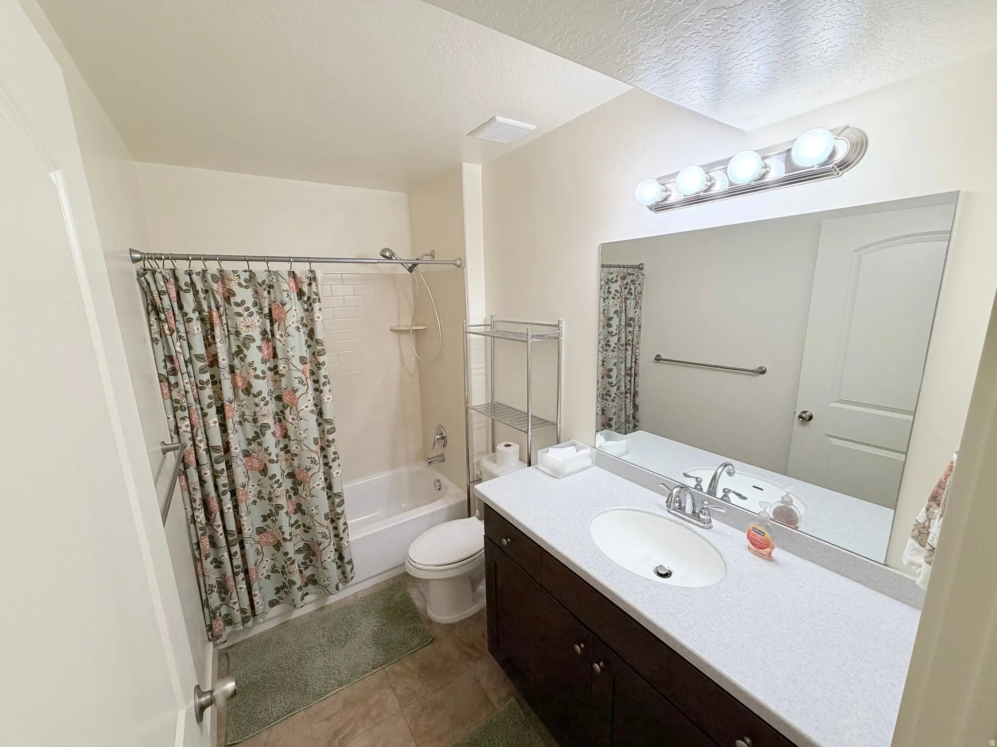 Full bathroom with a tub/shower combination featuring subway tile surround