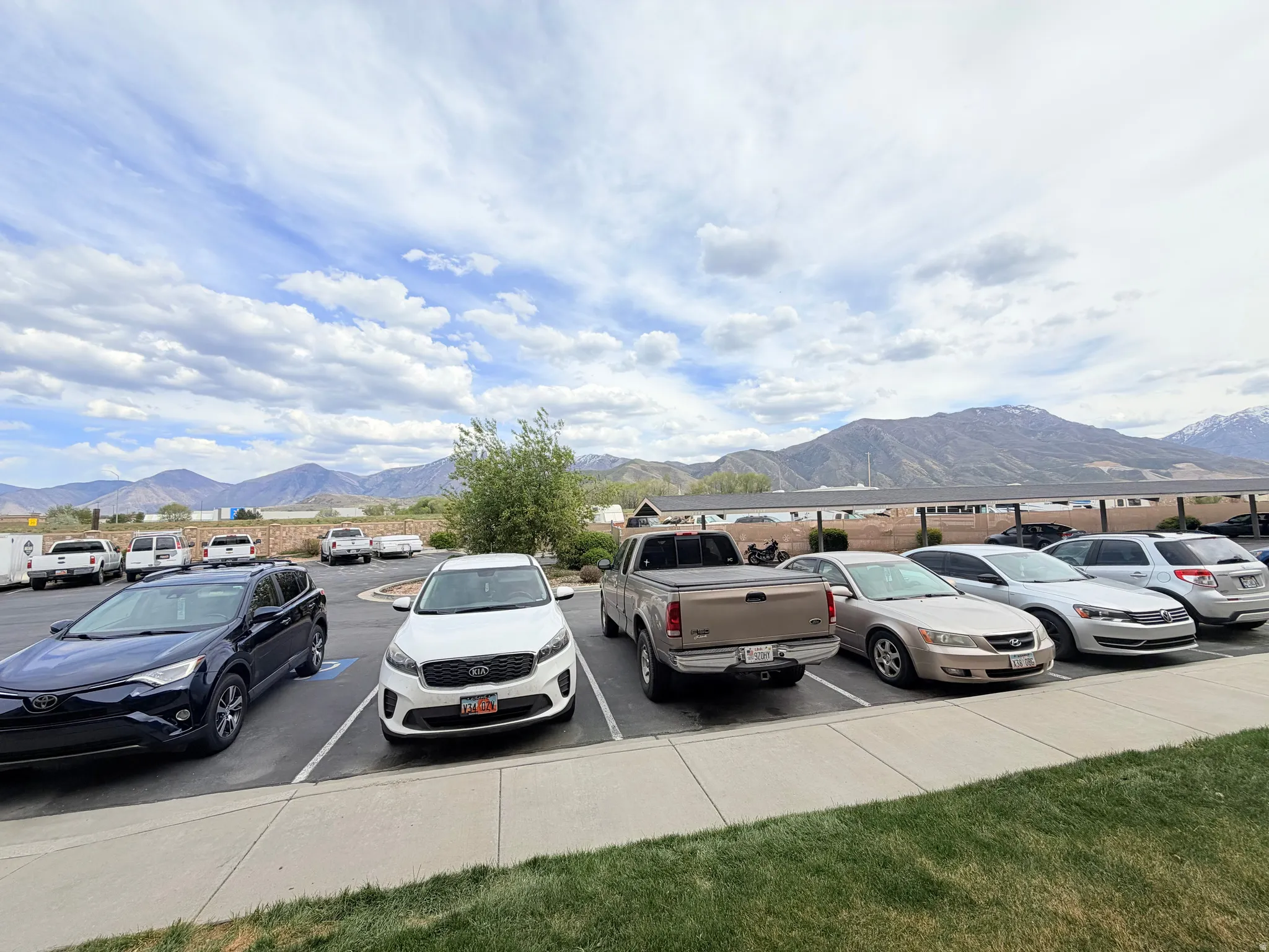 Uncovered parking lot featuring a mountain view