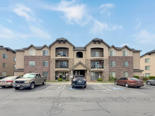 View of property featuring uncovered parking