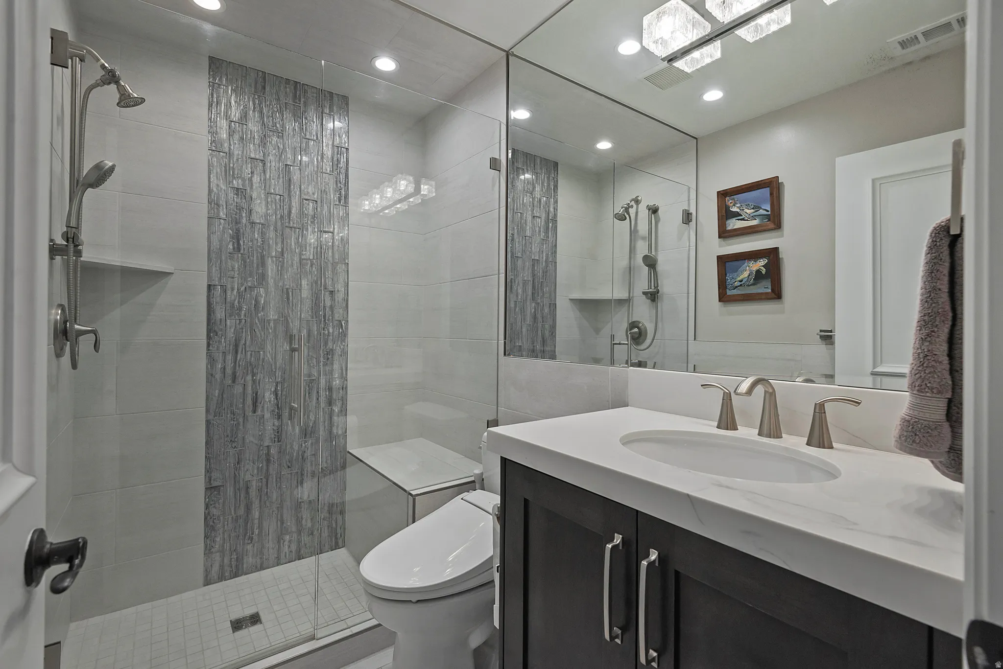Full bathroom with vanity, a shower stall, and recessed lighting