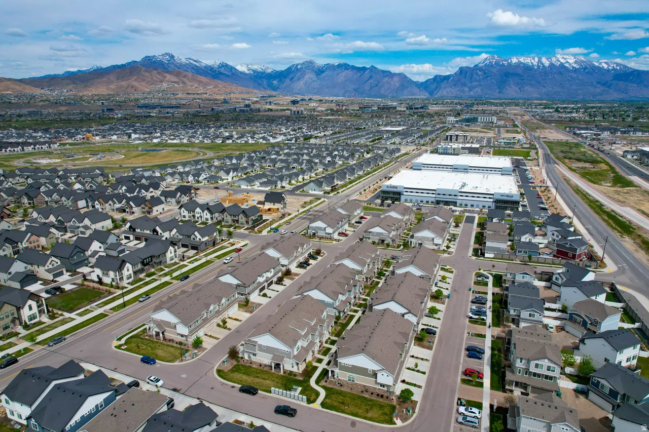 Aerial view of property and surrounding area with nearby suburban area and property parcel outlined