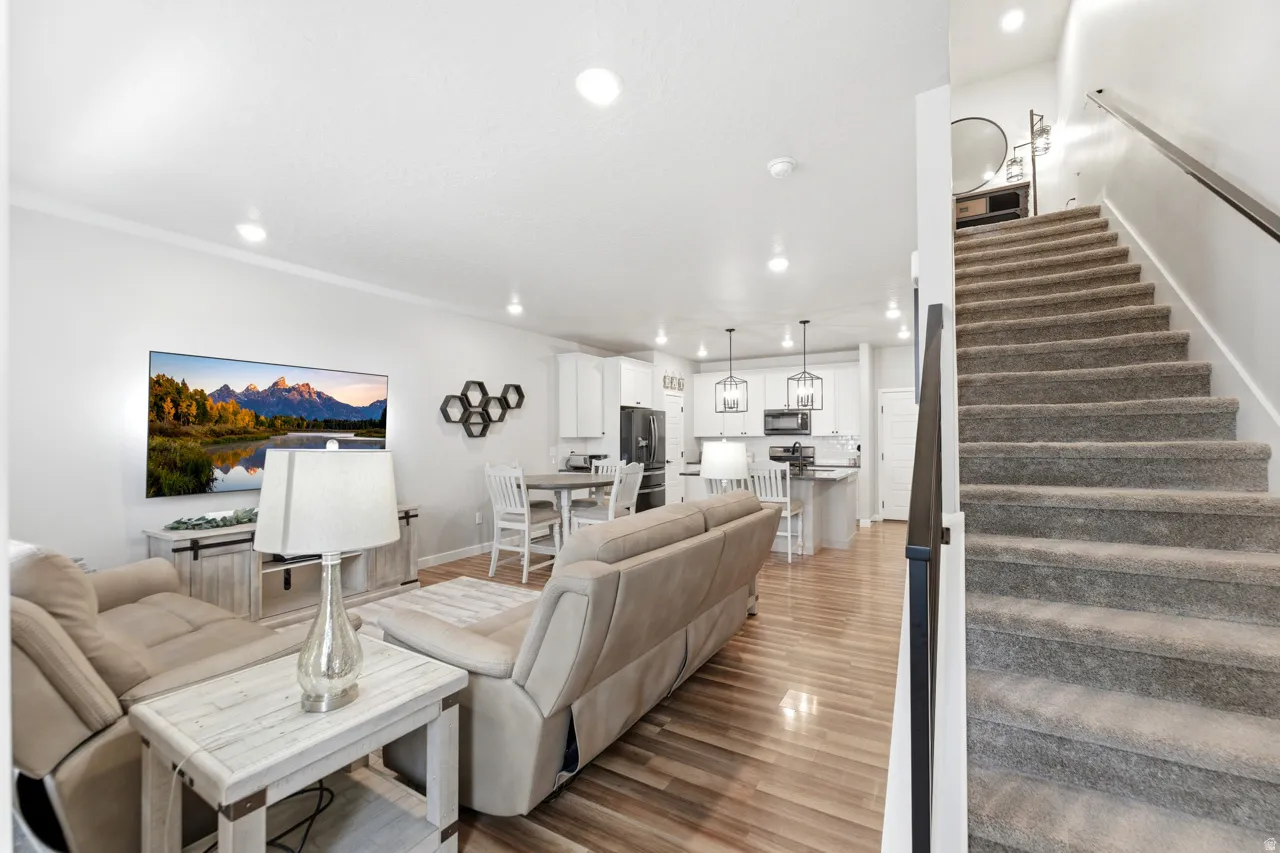 Living area with recessed lighting and light wood-style floors