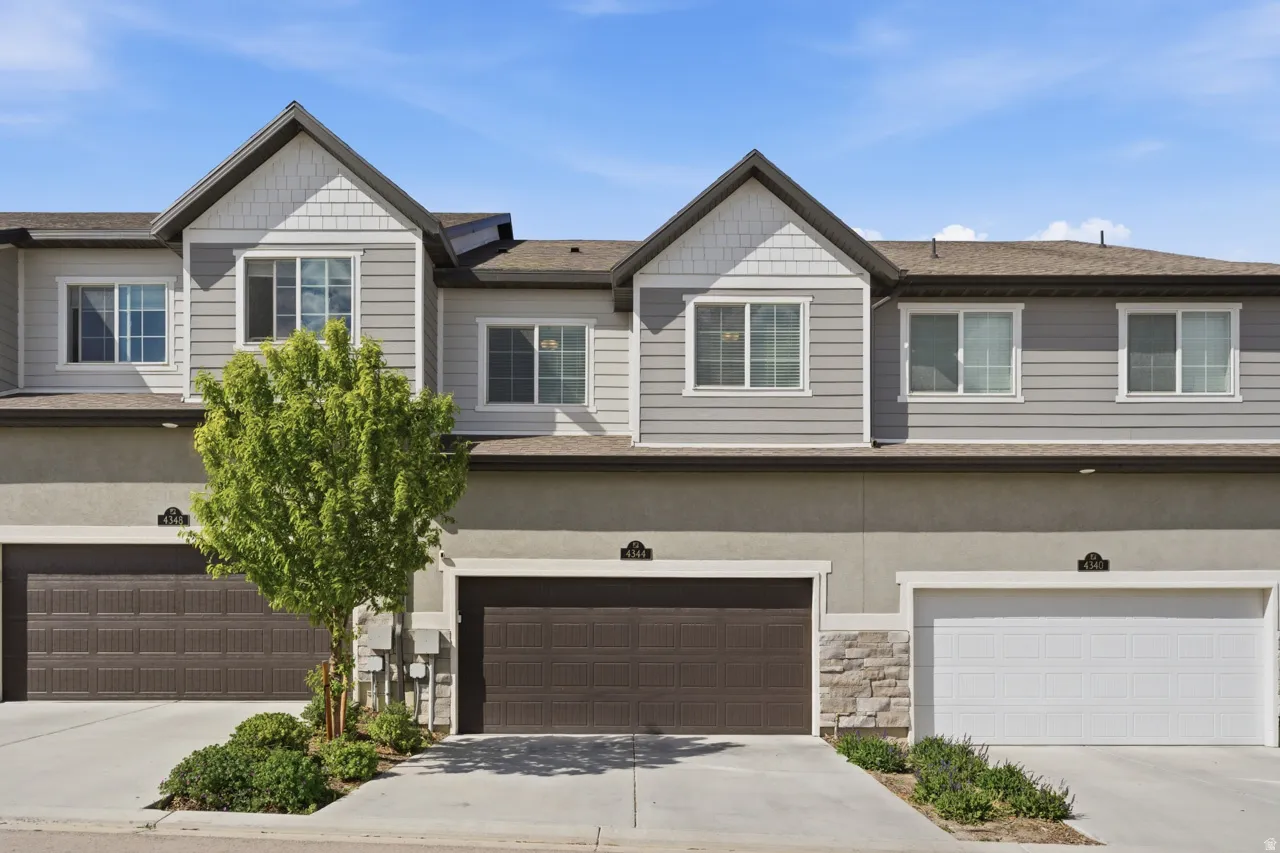 Craftsman inspired home with driveway, an attached garage, and stone siding