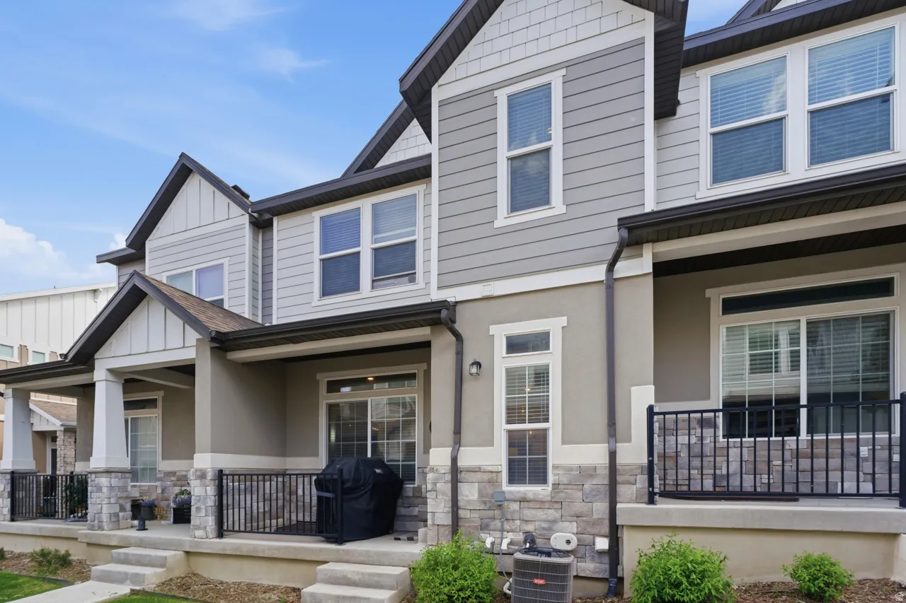 Craftsman inspired home with stone siding, covered porch, board and batten siding, and stucco siding