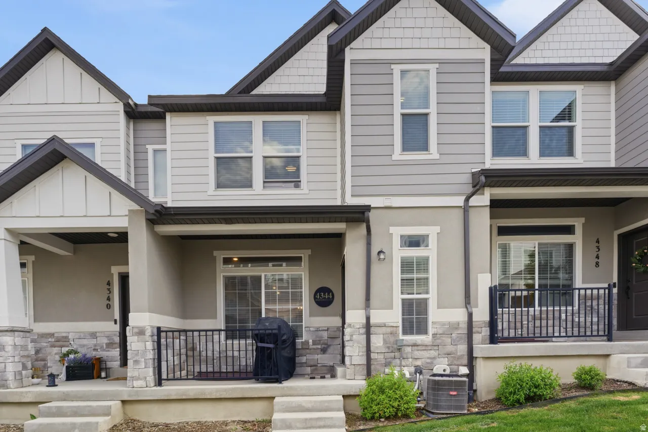Craftsman house with a porch, stone siding, and stucco siding