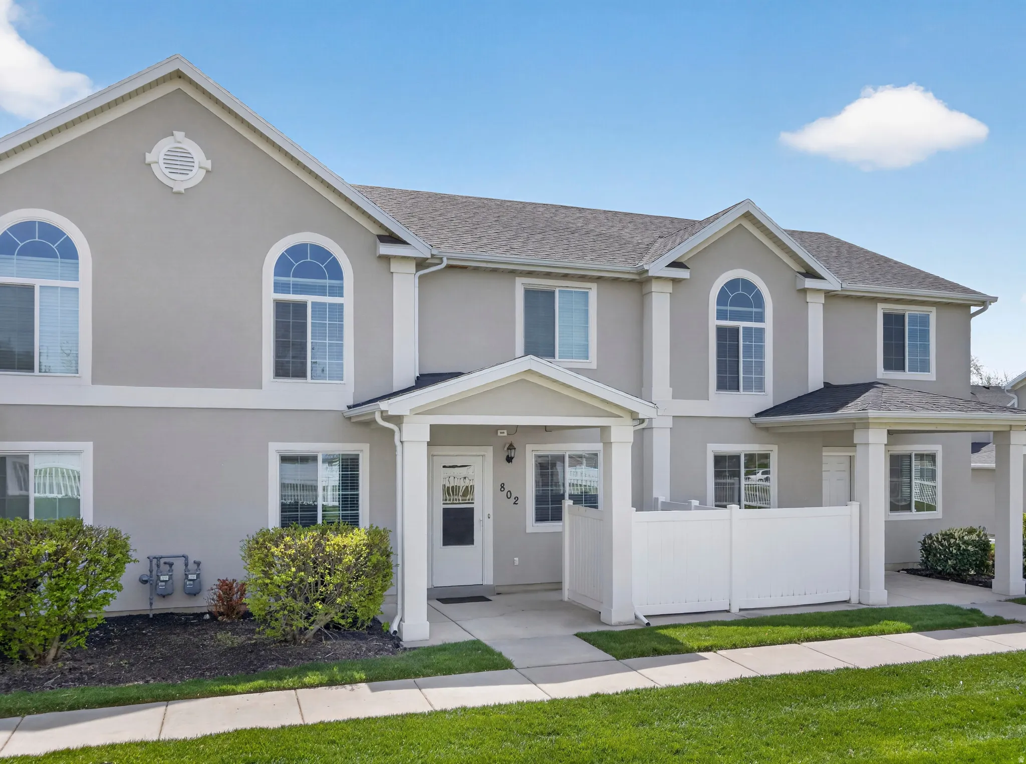View of front of home featuring stucco siding and a shingled roof