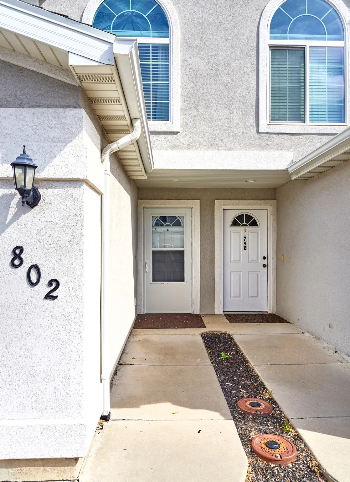 Property entrance featuring stucco siding
