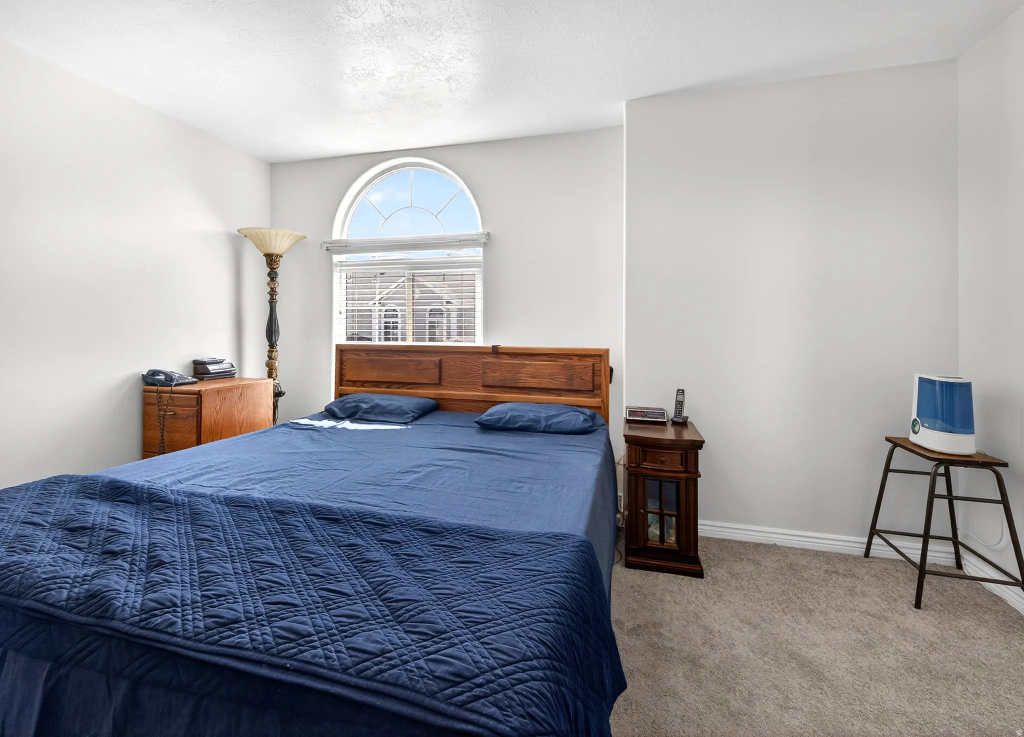 Bedroom with carpet floors and baseboards