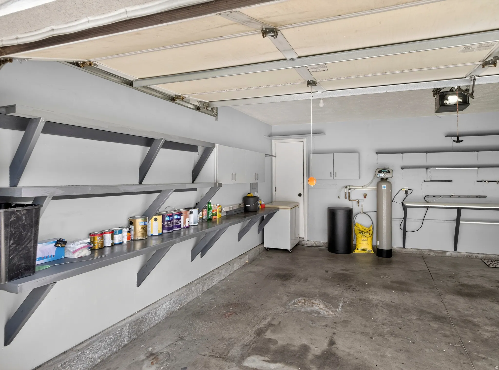 Garage with white fridge and a garage door opener