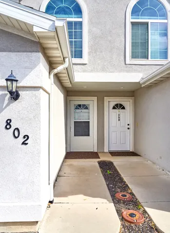 Property entrance featuring stucco siding