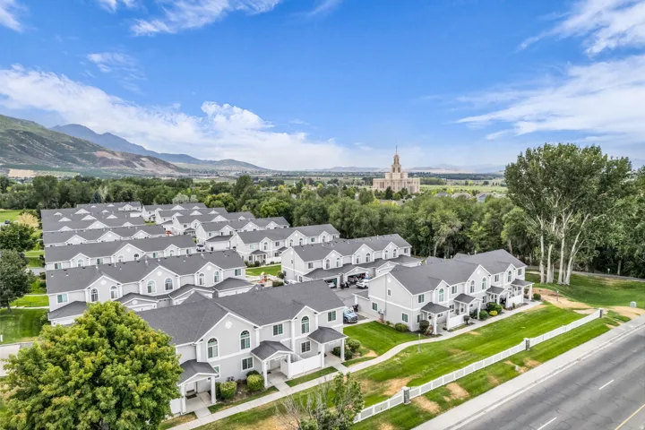 Townhome development with uniform grey exteriors and dark shingle roofs