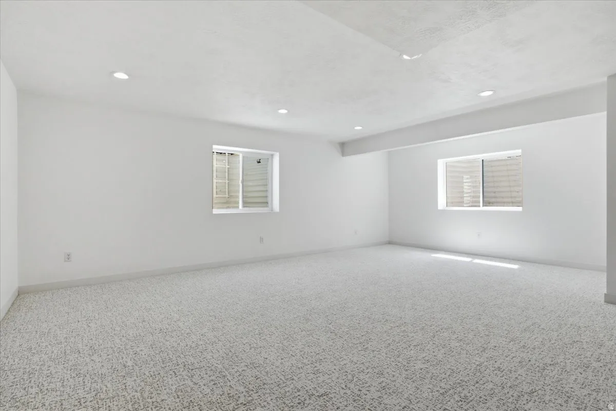 Unfurnished room featuring carpet and recessed lighting