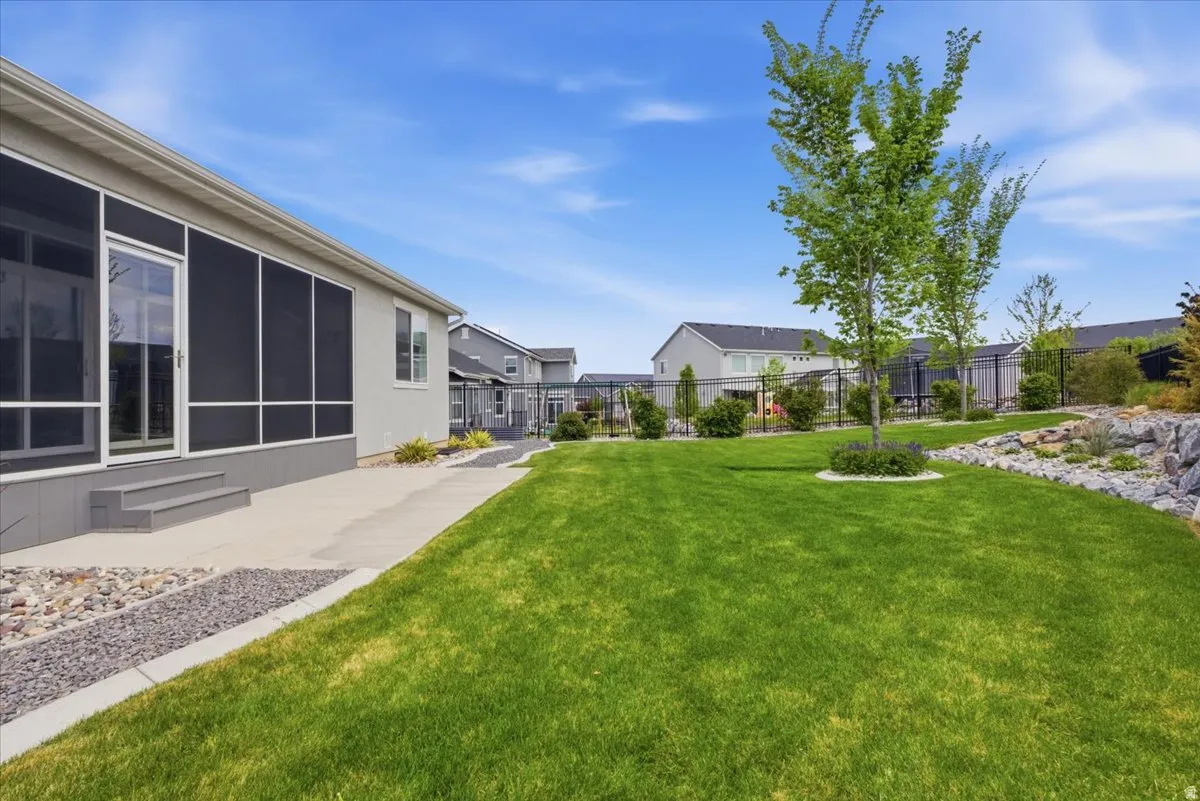 View of yard featuring a sunroom and a patio