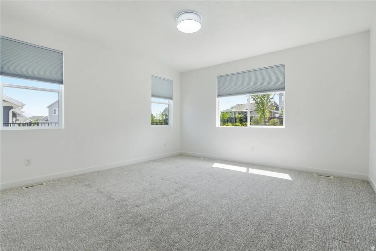 Empty room with carpet flooring and baseboards