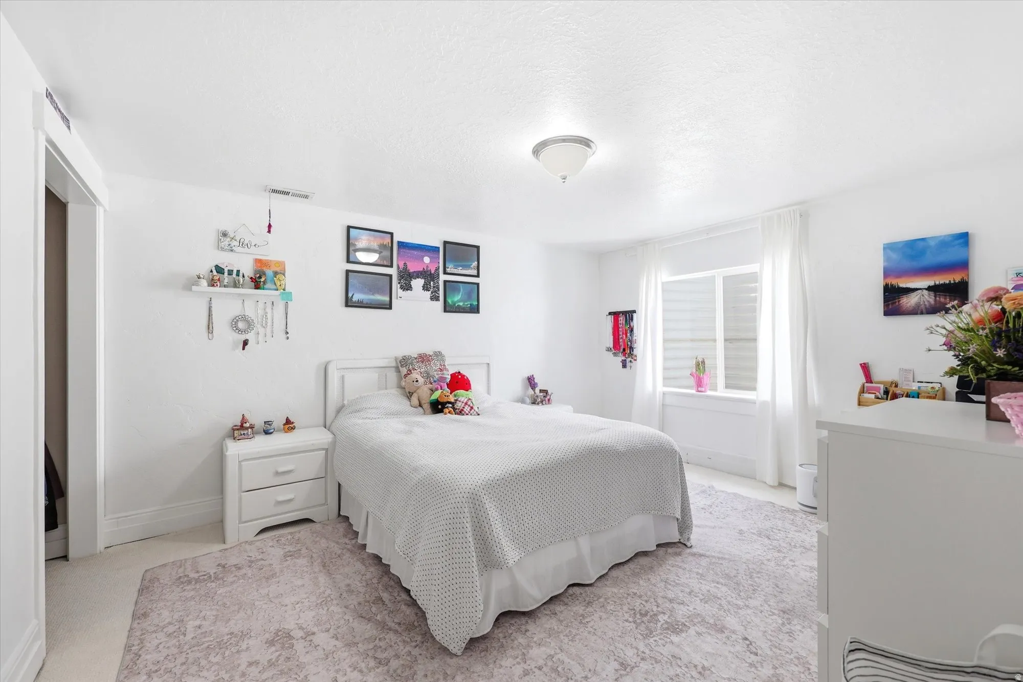 Bedroom featuring baseboards and a textured ceiling