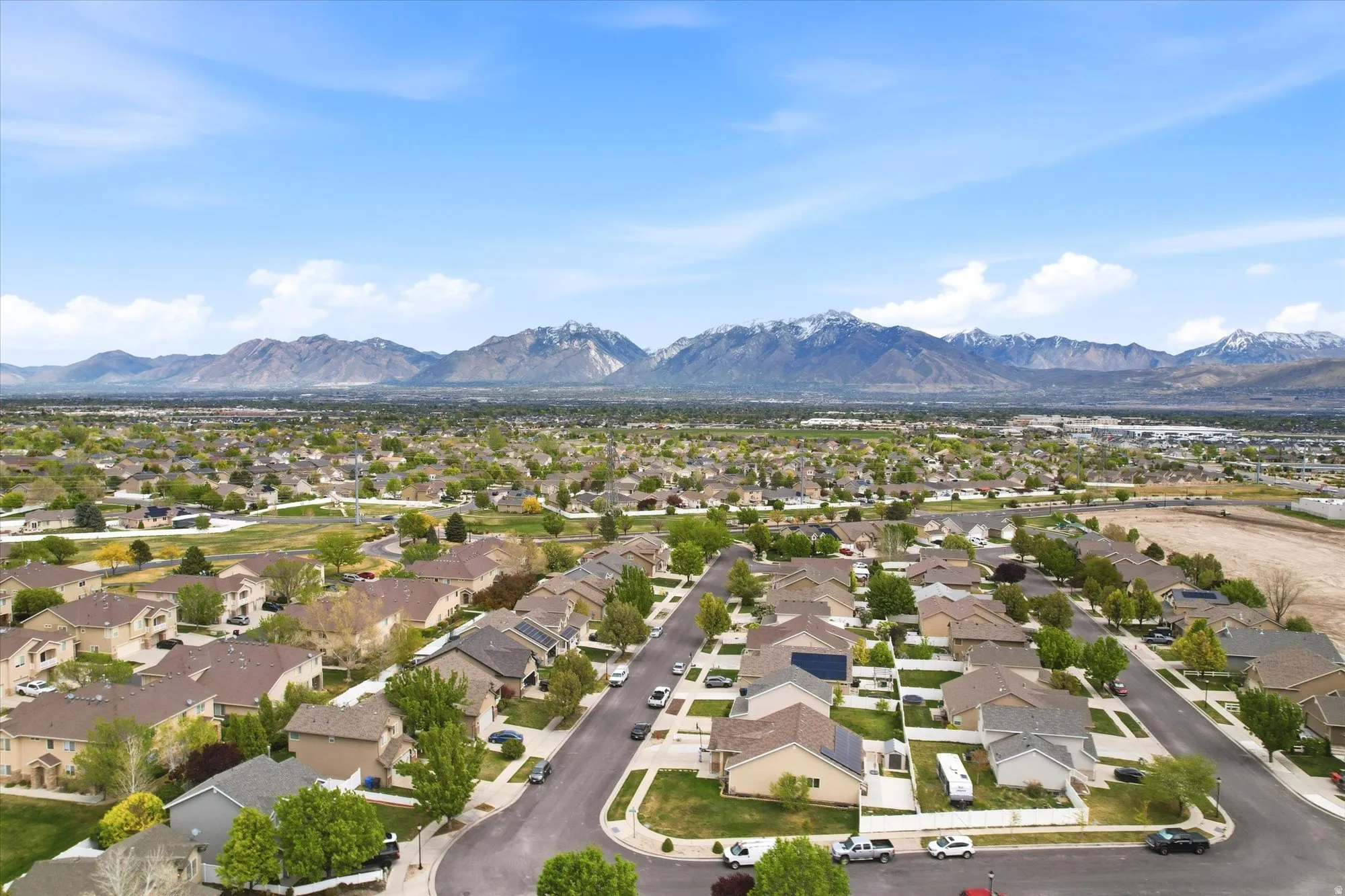 Aerial perspective of suburban area with a mountainous background
