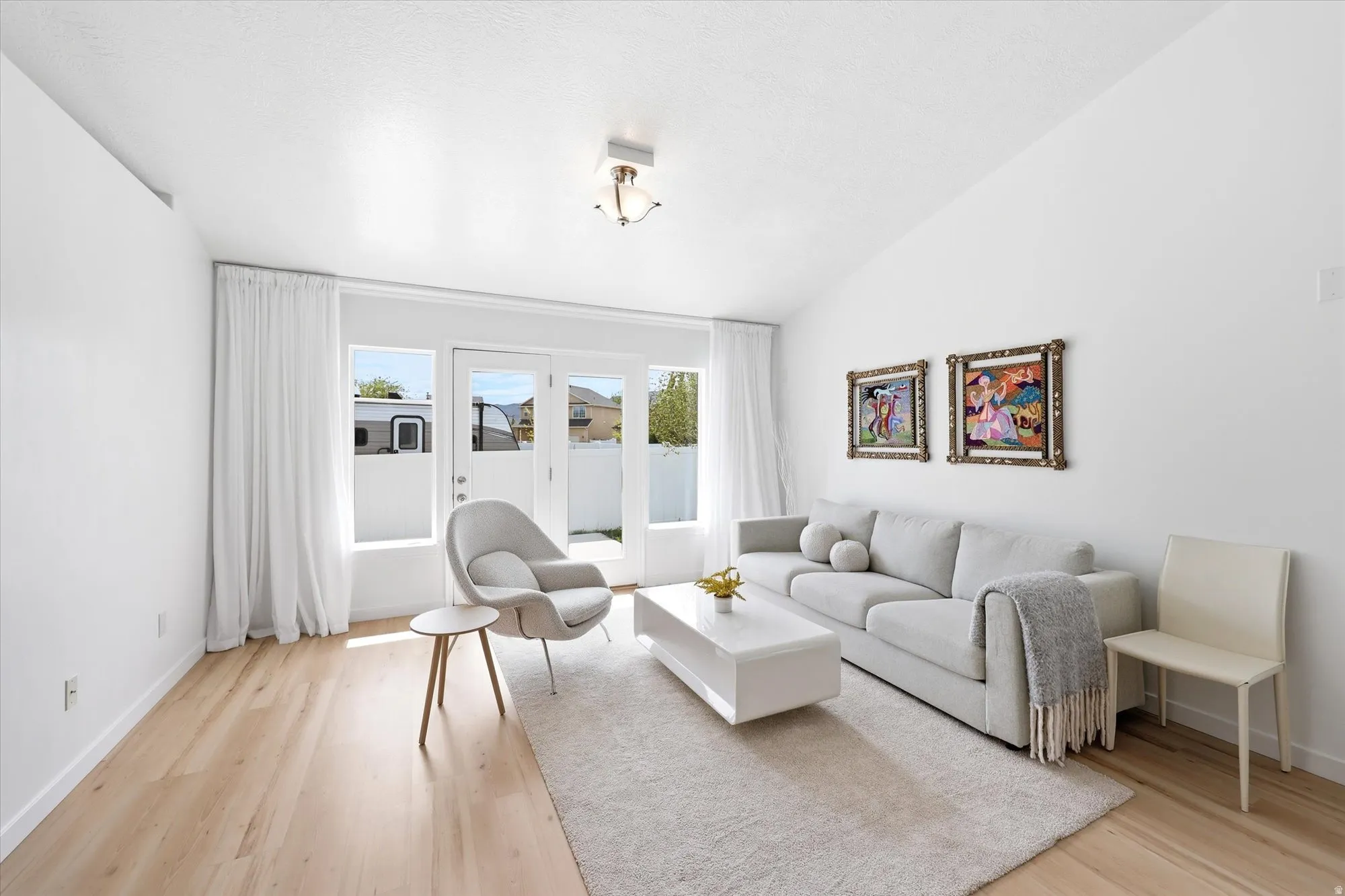 Living room featuring lofted ceiling and light wood-style flooring