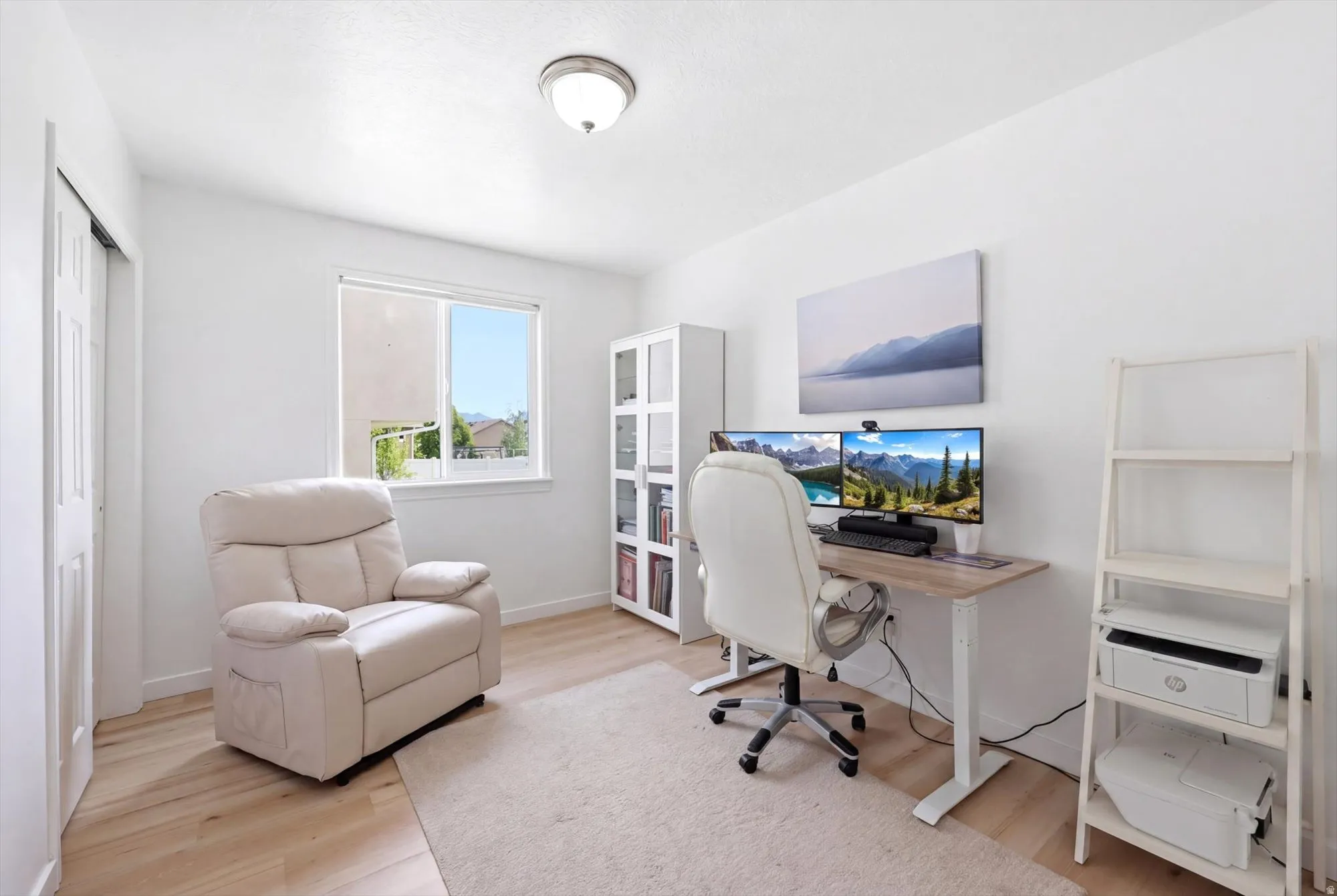 Home office with light wood-type flooring