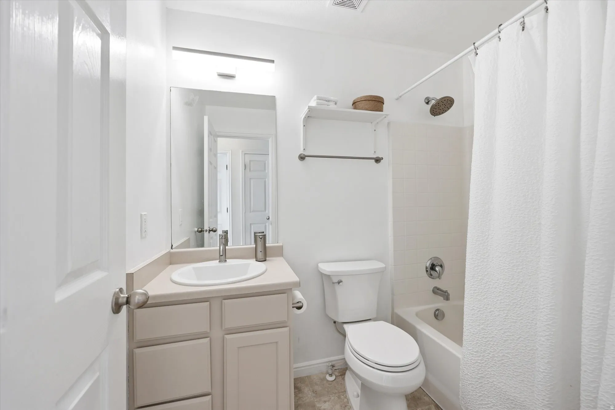 Full bathroom with vanity and shower / bath combination with curtain
